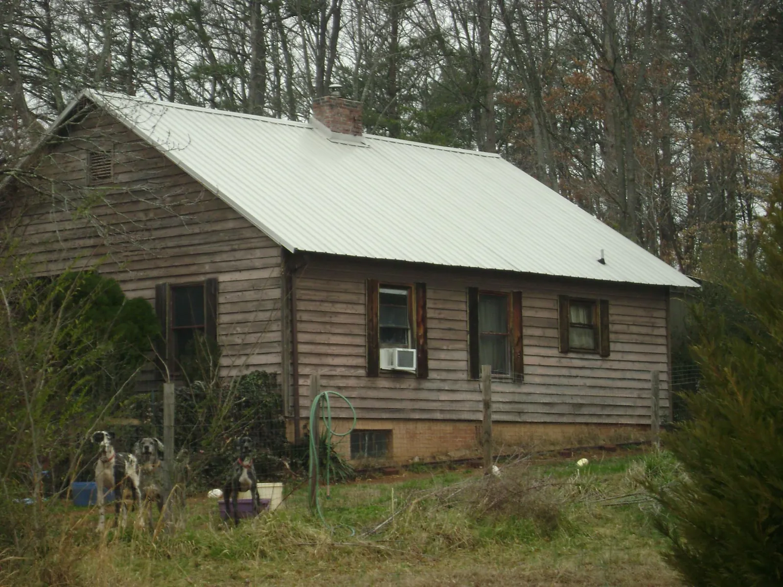 White metal roof on an old wood sided farmhouse, from a Metal Roof Installation job in South Greenfield